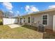 View of the backyard featuring a white fence, a patio, greenery, and an air conditioning unit at 818 Houston Ct, Haw River, NC 27258