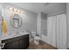A bathroom featuring a single vanity, bathtub with shower, and a neutral color scheme and hardwood flooring at 818 Houston Ct, Haw River, NC 27258