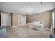 Spacious bedroom with a chandelier and a daybed with decorative pillows and a yellow pattern at 818 Houston Ct, Haw River, NC 27258