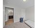 Neutrally painted bedroom with a glimpse of a bath with hardwood floor and decorative mirror over the sink at 818 Houston Ct, Haw River, NC 27258