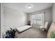 A simply decorated bedroom with a window bringing in natural light, carpet flooring and neutral walls at 818 Houston Ct, Haw River, NC 27258