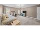 Cozy bedroom with plush carpeting, dual windows, and a decorative chandelier at 818 Houston Ct, Haw River, NC 27258