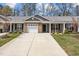 Charming townhome with brick facade, attached garage, and well-manicured front yard and mature trees at 818 Houston Ct, Haw River, NC 27258