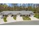 Aerial view of townhomes with well-maintained lawns, private driveways, and attached garages at 818 Houston Ct, Haw River, NC 27258