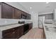 Modern kitchen with dark cabinetry, stainless steel appliances, and granite countertops at 818 Houston Ct, Haw River, NC 27258