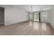 Bright living room with wood-look floors, sliding doors to the outdoors, and a modern chandelier at 818 Houston Ct, Haw River, NC 27258
