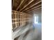 Unfinished basement featuring exposed framing, concrete floors, and a walkout to the backyard at 95 Parkland Dr, Pittsboro, NC 27312