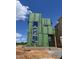 Modern home under construction with large windows, ZIP System sheathing, and a brick foundation at 95 Parkland Dr, Pittsboro, NC 27312