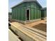 Exterior view of the unfinished construction with green sheathing, door, and lumber at 95 Parkland Dr, Pittsboro, NC 27312