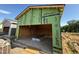 Unfinished garage showcasing framing and concrete floor, adjacent to a neighboring property at 95 Parkland Dr, Pittsboro, NC 27312