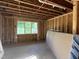 Interior view of unfinished room with exposed wooden beams and electrical wiring at 95 Parkland Dr, Pittsboro, NC 27312