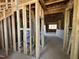 Unfinished interior with exposed framing, electrical wiring, and a view of an open room at 95 Parkland Dr, Pittsboro, NC 27312