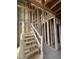 Unfinished staircase under construction with exposed framing and wood treads leading to the upper level at 95 Parkland Dr, Pittsboro, NC 27312
