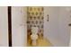 A bathroom with a toilet and a walk in shower, with floral wallpaper at 96 Overlook Rd, Cameron, NC 28326