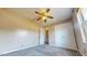 A bedroom with a ceiling fan, carpeted floors, and a view of the staircase through the doorway at 96 Overlook Rd, Cameron, NC 28326