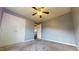 Cozy bedroom featuring neutral gray walls, ceiling fan and white closet doors at 96 Overlook Rd, Cameron, NC 28326