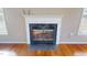 A close up of a fireplace with a white mantle and black surround in a home with hardwood floors at 96 Overlook Rd, Cameron, NC 28326