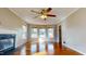 A bright living room with a ceiling fan, fireplace, and bay window for lots of natural light at 96 Overlook Rd, Cameron, NC 28326
