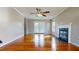 Bright living room with gleaming hardwood floors, a cozy fireplace, and glass doors at 96 Overlook Rd, Cameron, NC 28326