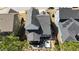 An aerial view of the backyard reveals a patio with seating, a hot tub, lush landscaping, and a well-maintained roof at 1025 Chelsea Run Ln, Apex, NC 27502