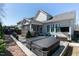 This backyard features a hot tub, screened porch, outdoor seating, and privacy fence at 1025 Chelsea Run Ln, Apex, NC 27502