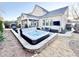 Backyard featuring a modern hot tub, outdoor seating area, landscaped yard, and a stylish exterior at 1025 Chelsea Run Ln, Apex, NC 27502