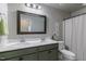 Bright bathroom features double sinks, quartz countertops, framed mirror and neutral walls at 1025 Chelsea Run Ln, Apex, NC 27502