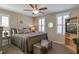 Comfortable bedroom with ceiling fan, plantation shutters, and a cozy gray upholstered bench at the foot of the bed at 1025 Chelsea Run Ln, Apex, NC 27502