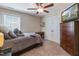 Cozy bedroom with ceiling fan, dresser with television, and double door closet at 1025 Chelsea Run Ln, Apex, NC 27502