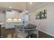 Bright dining area showcases a round table, stylish chairs, hardwood floors and modern lighting at 1025 Chelsea Run Ln, Apex, NC 27502
