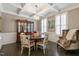 Elegant dining room featuring a coffered ceiling, dark hardwood floors, a large dining table, and tasteful decor at 1025 Chelsea Run Ln, Apex, NC 27502