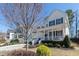 Inviting two-story home featuring a charming front porch and well-manicured landscaping at 1025 Chelsea Run Ln, Apex, NC 27502