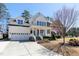 Charming two-story home featuring a cozy front porch and an attached two-car garage at 1025 Chelsea Run Ln, Apex, NC 27502
