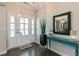 Bright and airy foyer featuring a glass-paneled front door, elegant decor, and gleaming hardwood floors at 1025 Chelsea Run Ln, Apex, NC 27502