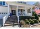 Beautiful home featuring a spacious front porch, brick steps, manicured landscaping, and a welcoming entryway at 1025 Chelsea Run Ln, Apex, NC 27502