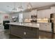 Spacious kitchen with a large center island, stainless steel appliances, white cabinets, and modern lighting fixtures at 1025 Chelsea Run Ln, Apex, NC 27502