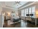Serene bedroom features tray ceilings, shutters, a desk and a comfortable bed and bench at 1025 Chelsea Run Ln, Apex, NC 27502
