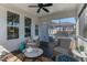 Cozy screened porch features woven chairs, a table, ceiling fan, and outdoor space at 1025 Chelsea Run Ln, Apex, NC 27502