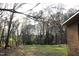 Expansive backyard with lush green lawn, bordered by mature trees offering shade and privacy at 105 Mary St, Carrboro, NC 27510