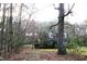Charming home featuring dormer windows and partial brick facade, with mature trees surrounding the house at 105 Mary St, Carrboro, NC 27510