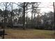 Charming home with dormer windows and a brick facade, set on a lot with mature trees and lawn at 105 Mary St, Carrboro, NC 27510