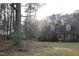 A well-maintained brick home with dormer windows set on a spacious lot with mature trees at 105 Mary St, Carrboro, NC 27510