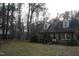 Charming brick home featuring dormer windows and a covered front porch surrounded by mature trees at 105 Mary St, Carrboro, NC 27510