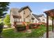 Lovely backyard with patio, green grass, lush landscaping, and an expansive wooden deck at 1100 Dotson Way, Apex, NC 27523