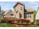 Charming home with a manicured backyard featuring beautiful landscaping and a well-maintained lawn at 1100 Dotson Way, Apex, NC 27523