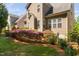 Charming home with a manicured backyard featuring beautiful landscaping and a well-maintained lawn at 1100 Dotson Way, Apex, NC 27523