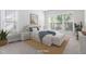 This bedroom features a bed, windows, bedside tables and lamps, and neutral decor at 1100 Dotson Way, Apex, NC 27523