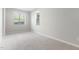 Bedroom with neutral paint and carpet, natural lighting from two windows, and white trim at 1100 Dotson Way, Apex, NC 27523