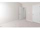 This bedroom features neutral carpet, fresh paint and a door to the hallway at 1100 Dotson Way, Apex, NC 27523