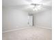 Bright bedroom with neutral carpet and ceiling fan has access to an open door and hallway at 1100 Dotson Way, Apex, NC 27523